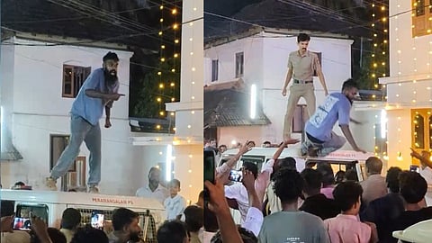Young man dances on top of police jeep