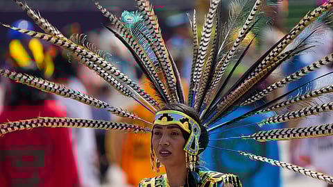 A woman in Indigenous dress attends a state funeral ceremony commemorating the 500th anniversary of the execution of Cuauhtemoc, the last Aztec emperor of Tenochtitlán
