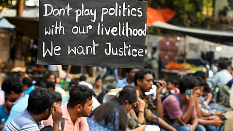 Teachers and non-teaching staff, dismissed from government-aided schools, during their sit-in protest in Kolkata