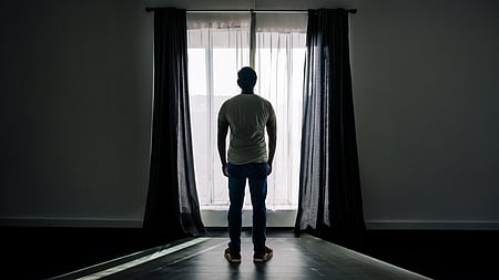 Thanatophobia, man standing infront of window