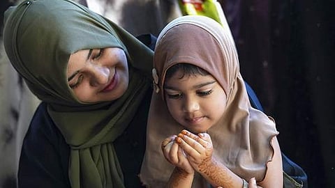 woman and daughter praying happy eid al adha 2025 bakrid 