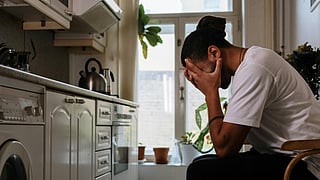 Man sitting in a chair with mental stress