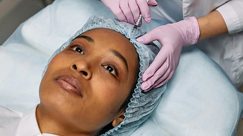 Dermatologist Injecting Botox on Client's Forehead