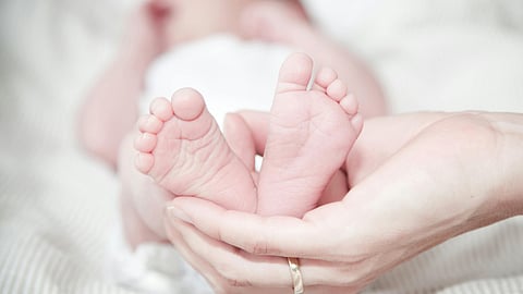 Close-up of Hands Holding Baby Feet