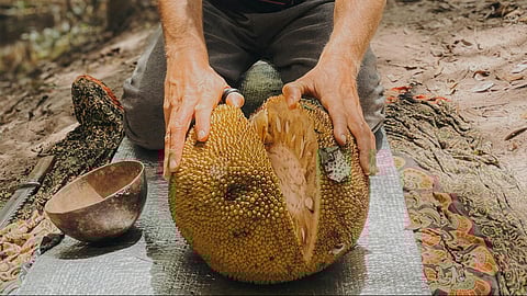 man cutting jackfruit