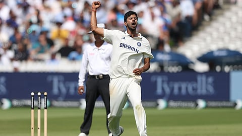 Washington Sundar celebrates after taking a wicket.