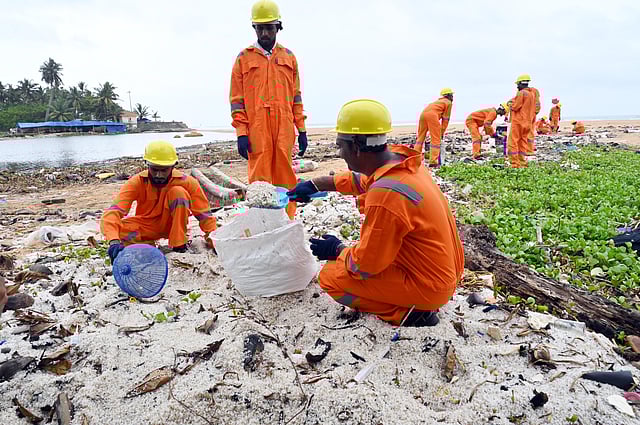 Image of Sanitation workers remove plastic waste