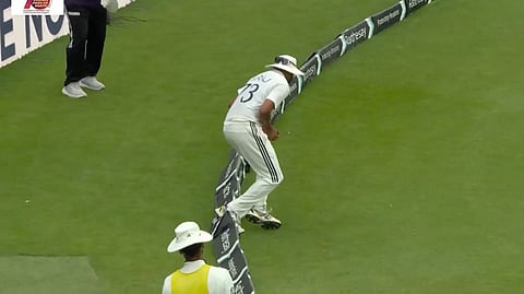 Mohammed Siraj touches the boundary line after taking a catch