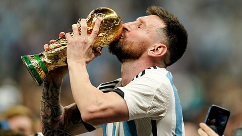 Lionel Messi with World Cup trophy
