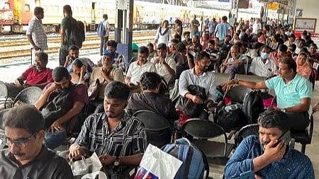 train travellers waiting at railway station 