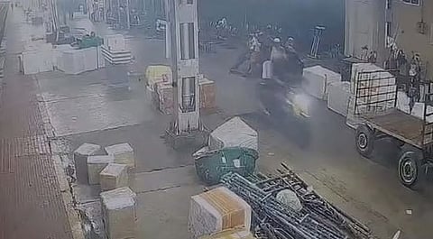 Youth riding a luxury bike through Ernakulam North railway station platform