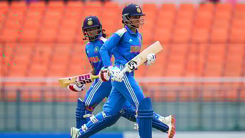 India's Smriti Mandhana, front, and Pratika Rawal run between the wickets during the first ODI cricket match between India Women and Australia Women