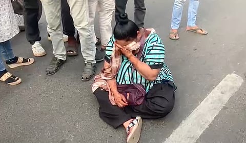 woman sits on road in Gujarat's Vadodara causing chaos