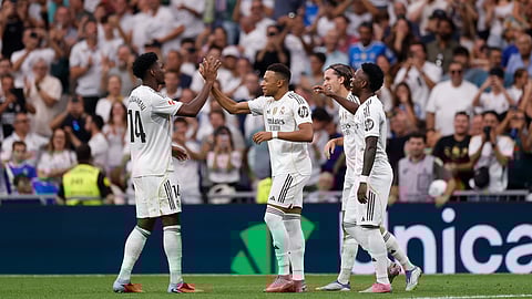 Real Madrid players celebrate a goal