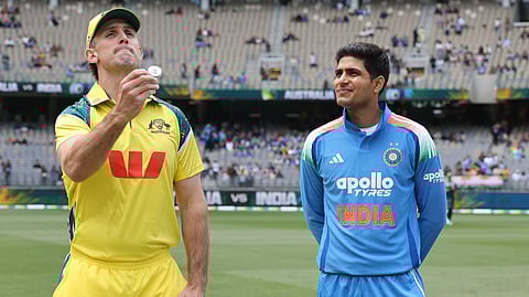 Mitchell Marsh tosses. Shubman Gill is nearby.