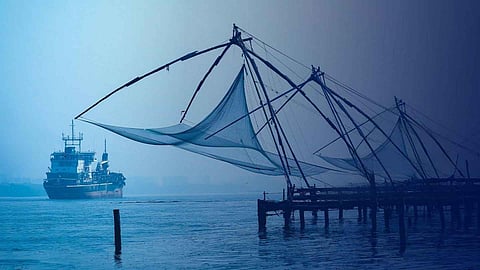 Fort Kochi landscape. a ship passing beside chineese fishing nets.