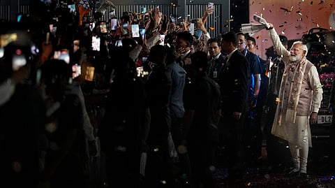 Prime Minister Narendra Modi waves a gamcha as he arrives during the celebration of NDAs victory in the Bihar Assembly elections
