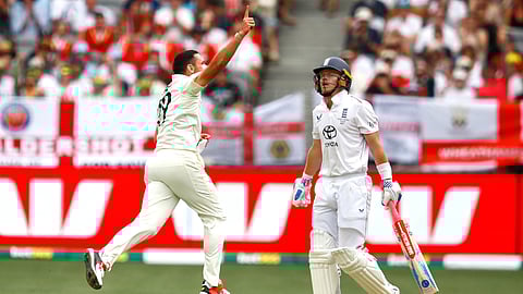 Scott Boland, left, celebrates the wicket of England's Ollie Pope