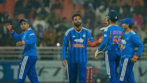 Varun Chakravarthy, second left, celebrates with teammates after taking the wicket of Reeza Hendricks