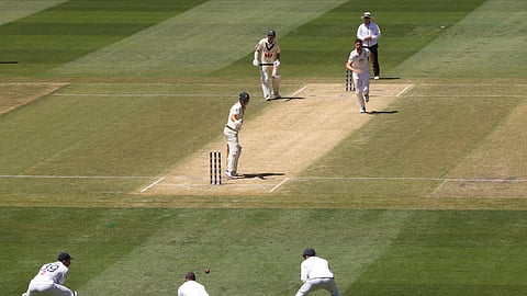 Australia's Marnus Labuschagne, center, turns to see England's Joe Root