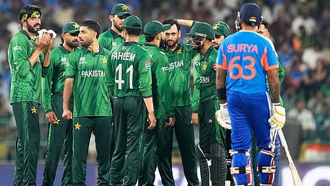 Pakistan 's players wait for the third umpire's decision for the wicket of India's captain Suryakumar Yadav