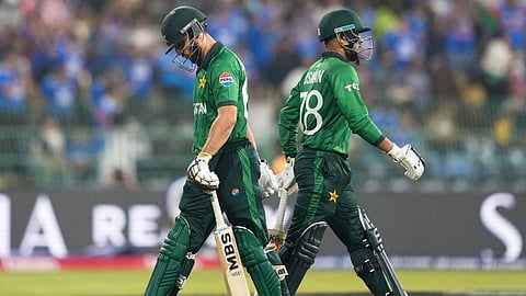 Pakistan's captain Salman Ali Agha, left, leaves the ground after losing his wicket as teammate Usman Khan walks in during the T20 World Cup cricket match