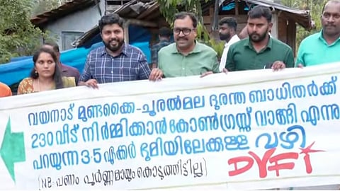 DYFI sets up board on land acquired by Congress in Wayanad