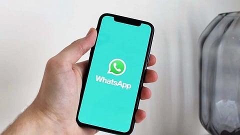 image of a smartphone with WhatsApp as wallpaper