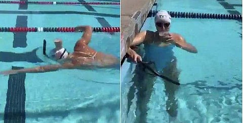 തലയില്‍ ഒരു ക്ലാസ് പാല്‍, ഒരു തുള്ളി പോലും തുളുമ്പാതെ നീന്തി കടന്ന് അമേരിക്കയുടെ ഒളിംപിക് ചാമ്പ്യന്‍