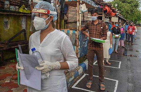 കോവിഡ് സുരക്ഷാ മുന്‍കരുതലുകളുമായി ജെഇഇ പരീക്ഷാ ഹാളിലേക്കു കടക്കാനൊരുങ്ങുന്ന വിദ്യാര്‍ഥികള്‍-പിടിഐ