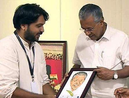 ഇബ്രാഹിം ബാദുഷ വരച്ച കാര്‍ട്ടൂണ്‍ മുഖ്യമന്ത്രിയ്ക്ക് കൈമാറുന്നു / ചിത്രം ഫെയ്‌സ്ബുക്ക്‌
