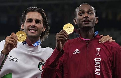 അമുഅതസ് ബര്‍ഷീമും ഗിയാന്‍ മാര്‍ക്കോ ടംബേറിയും സ്വര്‍ണ മെഡലുമായി/എപി