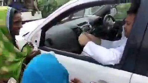 കാറിന് മുന്നില്‍ തടിച്ചുകൂടിയ സ്ത്രീകള്‍ക്ക് നോട്ടുകള്‍ വിതരണം ചെയ്യുന്ന തേജസ്വി യാദവ്