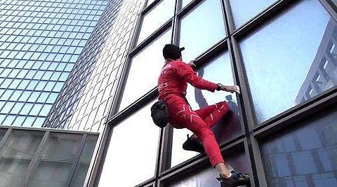 മുകളിലേക്ക് പിടിച്ചുകയറുന്ന അലെയ്ന്‍ റോബര്‍ട്ടിന്റെ ദൃശ്യം