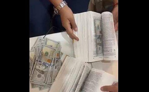 പുസ്തകതാളുകളില്‍ ഒളിപ്പിച്ച നിലയില്‍ ഡോളര്‍ നോട്ടുകള്‍, എഎന്‍ഐ