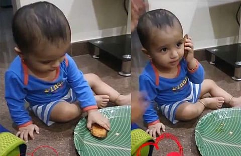 കുട്ടി ഭക്ഷണം ഫോണായി ഉപയോ​ഗിക്കുന്നു/ വിഡിയോ സ്ക്രീൻഷോട്ട്