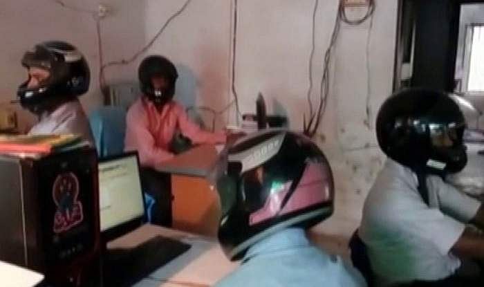 ഓഫിസില്‍ ഹെല്‍മെറ്റ് ധരിച്ച് സര്‍ക്കാര്‍ ഉദ്യോഗസ്ഥര്‍; ഇല്ലേല്‍ ജീവന്‍ പോകും